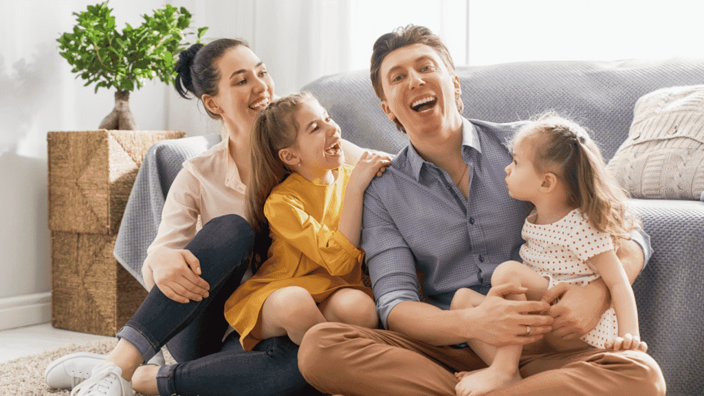 Family with two young children sitting together at home